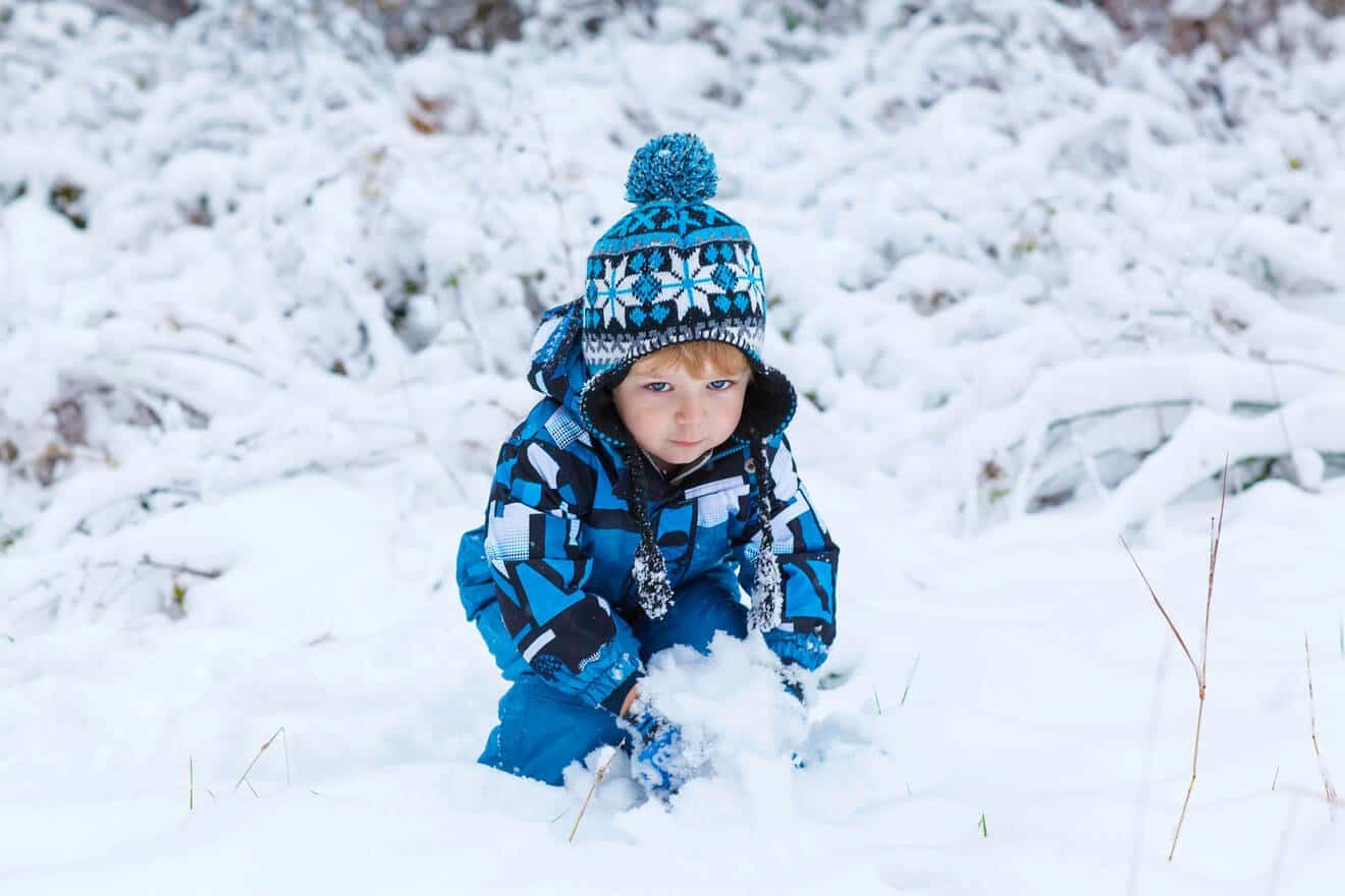 boy playing in the snow