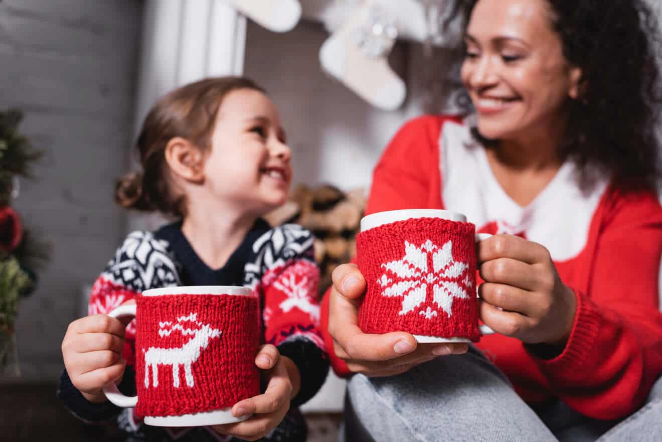 mom and girl holding mugs