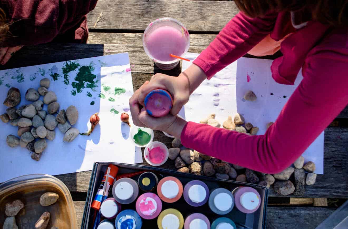 girl getting ready for rock painting