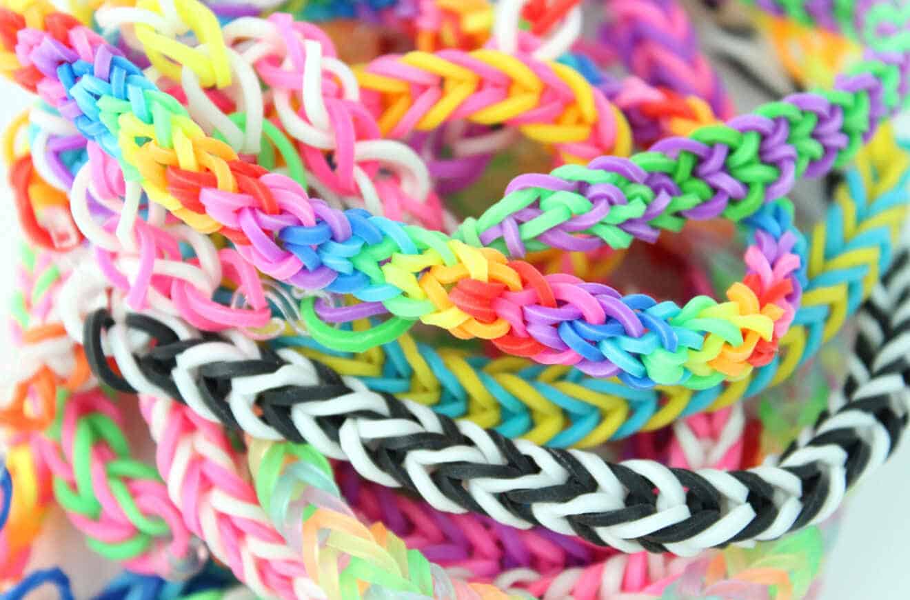 A vibrant mix of rubber bands with various designs, creating a colorful pile of stretchy goodness!