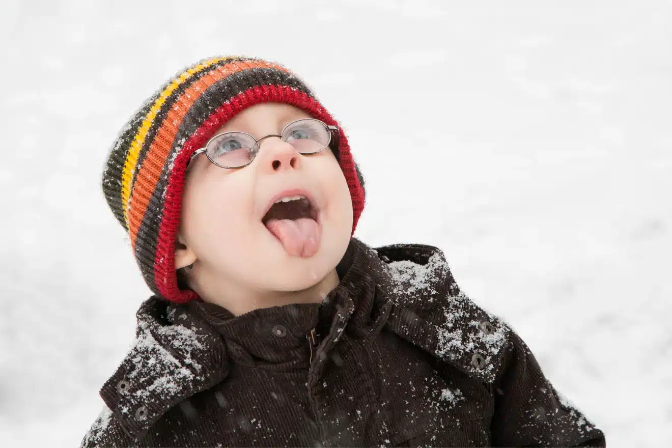 boy catching snow with his tongue