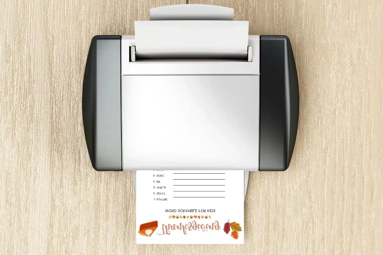 A fax machine prints a sheet with a Thanksgiving shopping list and autumn-themed decorations.