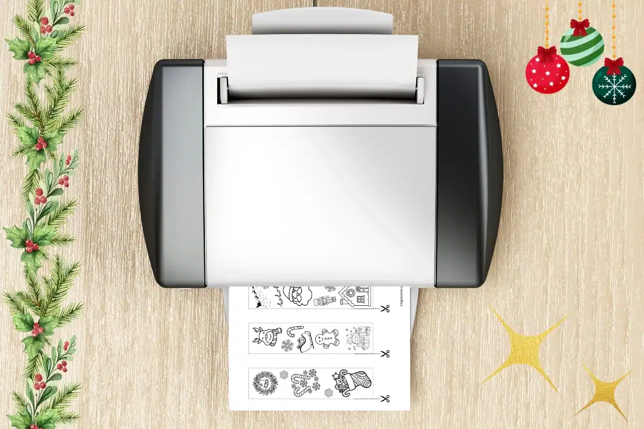 A printer on a wooden table prints holiday-themed designs. Two Christmas ornaments and a garland decorate the corners.