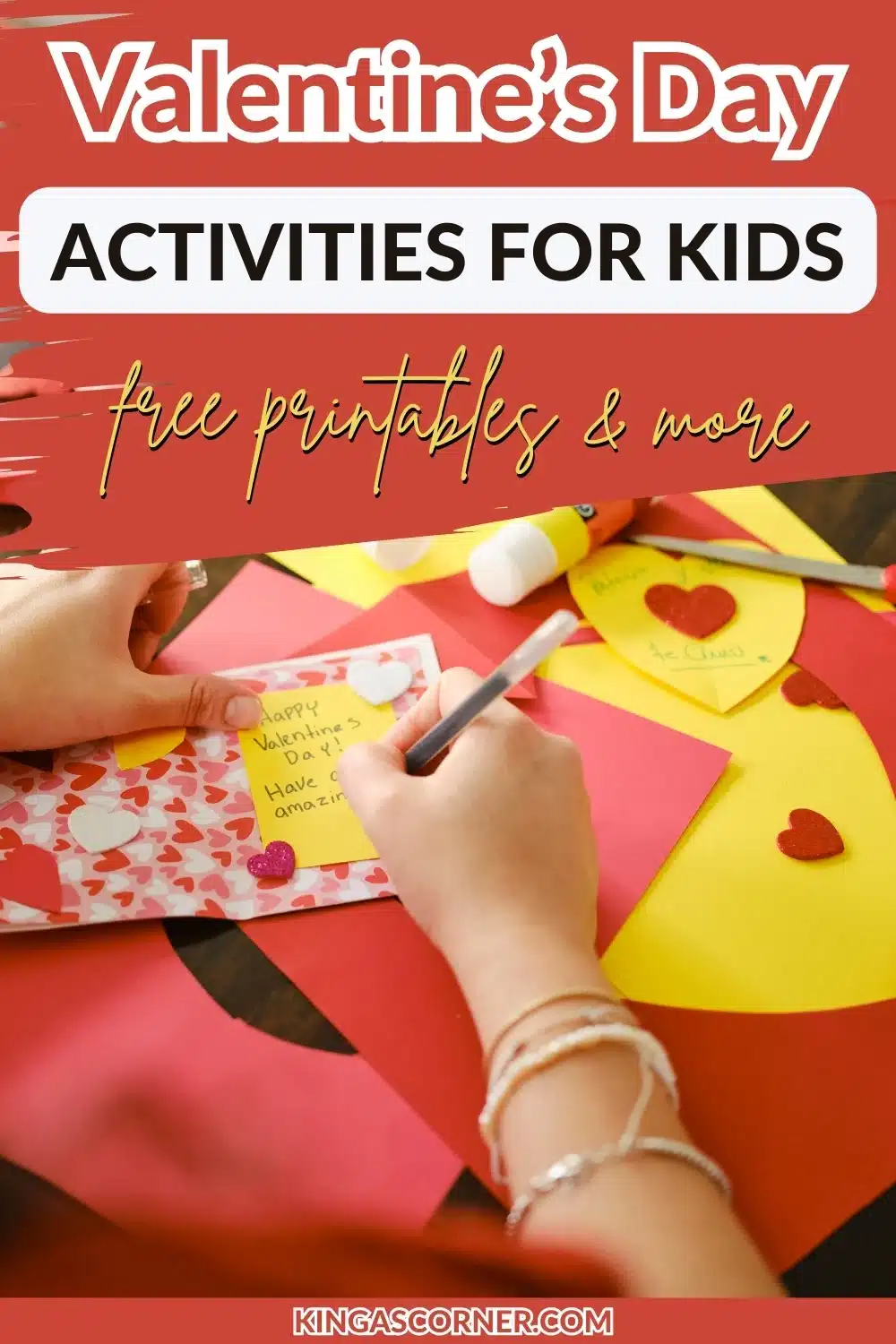 Crafting Valentine's cards with pink and yellow paper, hearts, and a glue stick on a table.