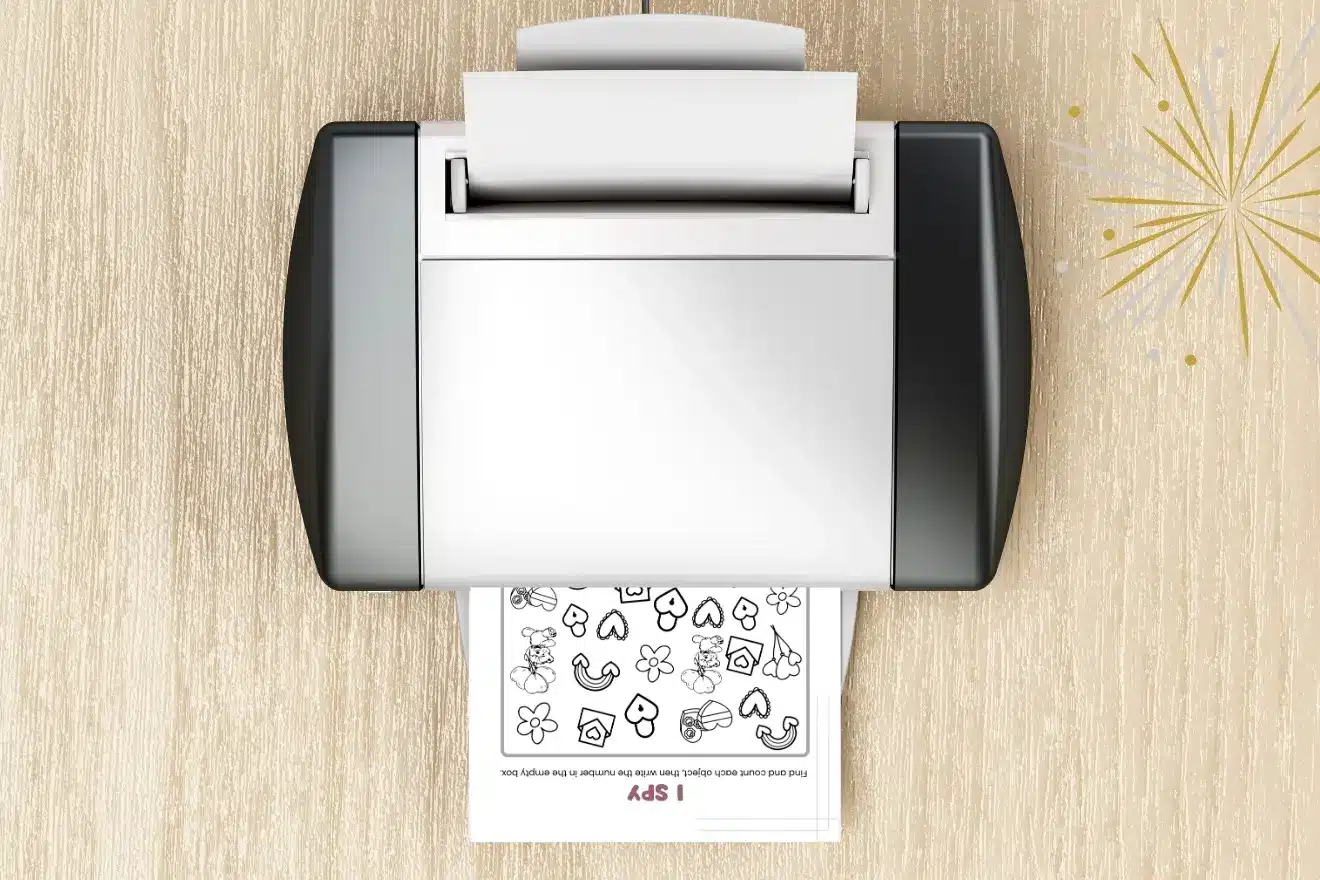 Flatbed scanner on a wooden surface, scanning a sheet with various outlined shapes and symbols.