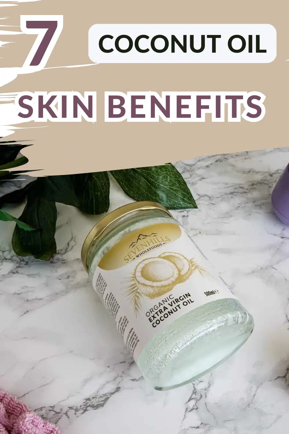 A jar of organic extra virgin coconut oil lies on a marble surface with text above reading “7 Coconut Oil Skin Benefits.”.