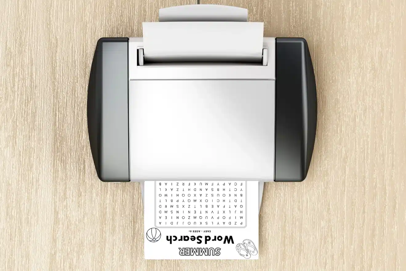 A printer on a wooden surface prints a word search puzzle sheet labeled "SUMMER Word Search.